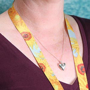 Buttonsmith Van Gogh Sunflower Lanyard being worn against bare skin on neck